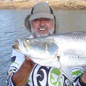 Man holding big barramundi and rod